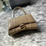 Curvy-Silhouette-Hourglass-XS-Top-Handle-Shiny-Calfskin-Tote-Apricot-Curvy-Silhouette-Hourglass-XS-Top-Handle-Shiny-Calfskin-Tote-Apricot-1.webp
