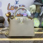 Elegant-Top-Handle-Mini-Bag-in-Golden-Champagne-M22436-BB-Elegant-Top-Handle-Mini-Bag-in-Golden-Champagne-M22436-BB-1.webp