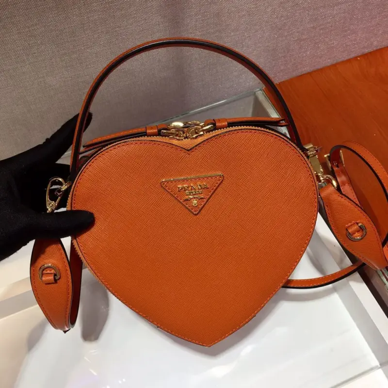Heart-Shaped-Saffiano-Leather-Odette-Crossbody-Shoulder-Bag-1BH144-Orange-Heart-Shaped-Saffiano-Leather-Odette-Crossbody-Shoulder-Bag-1BH144-Orange-1.webp