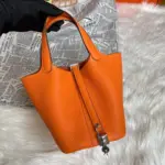 Orange-Lock-Top-Handle-Bag-in-Clemence-Grained-Leather-18-Orange-Lock-Top-Handle-Bag-in-Clemence-Grained-Leather-18-3.webp