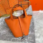 Orange-Lock-Top-Handle-Bag-in-Clemence-Grained-Leather-22-Orange-Lock-Top-Handle-Bag-in-Clemence-Grained-Leather-22-1.webp