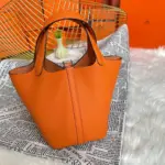 Orange-Lock-Top-Handle-Bag-in-Clemence-Grained-Leather-22-Orange-Lock-Top-Handle-Bag-in-Clemence-Grained-Leather-22-2.webp