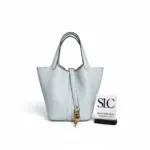 Pale-Blue-Picotin-Lock-Bucket-Bag-in-Taurillon-Clemence-Pale-Blue-Picotin-Lock-Bucket-Bag-in-Taurillon-Clemence.webp