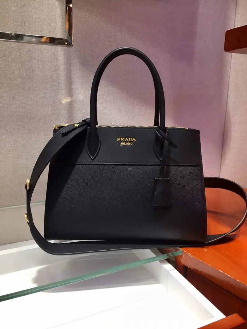 Structured-Paradigme-Top-Handle-Bag-in-Saffiano-Leather-1BA102-1-Black-Structured-Paradigme-Top-Handle-Bag-in-Saffiano-Leather-1BA102-1-Black-1.webp