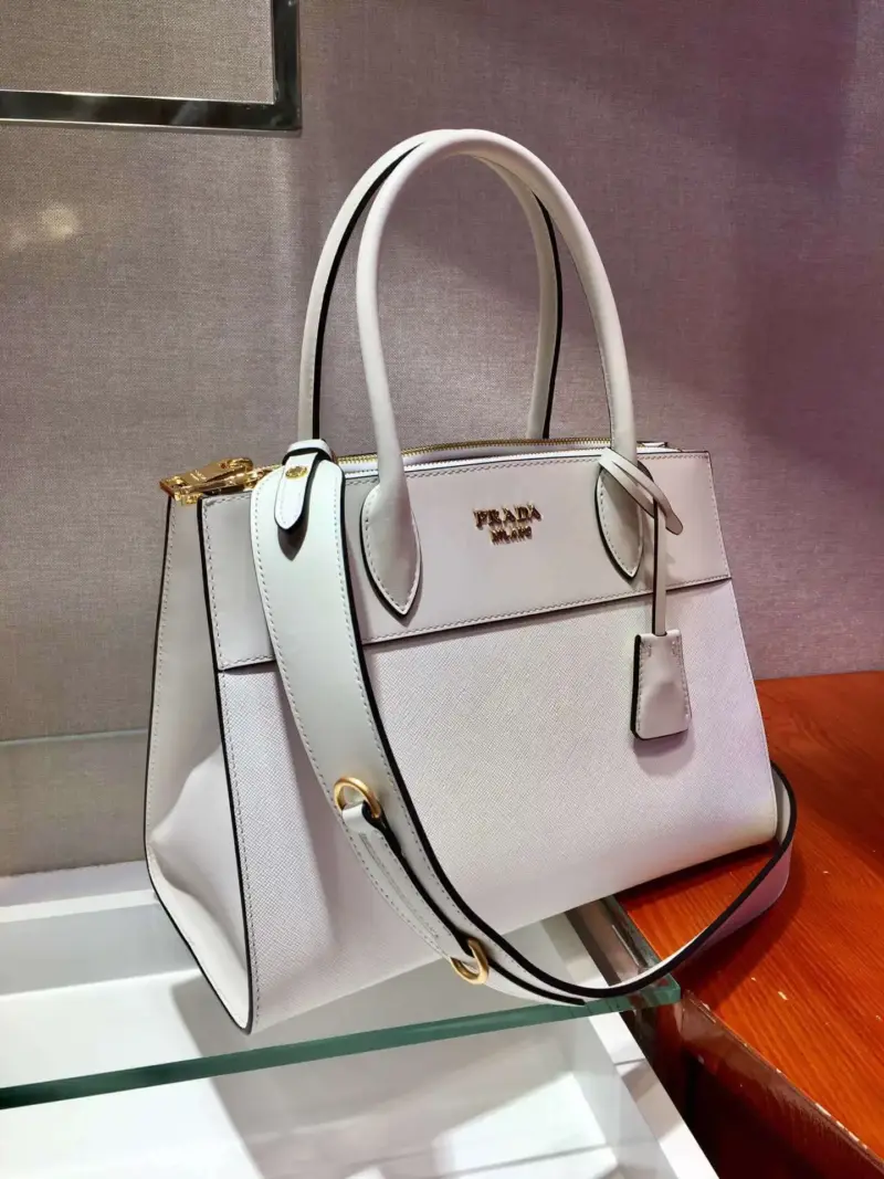Structured-Paradigme-Top-Handle-Bag-in-Saffiano-Leather-1BA102-1-White-Structured-Paradigme-Top-Handle-Bag-in-Saffiano-Leather-1BA102-1-White-2.webp